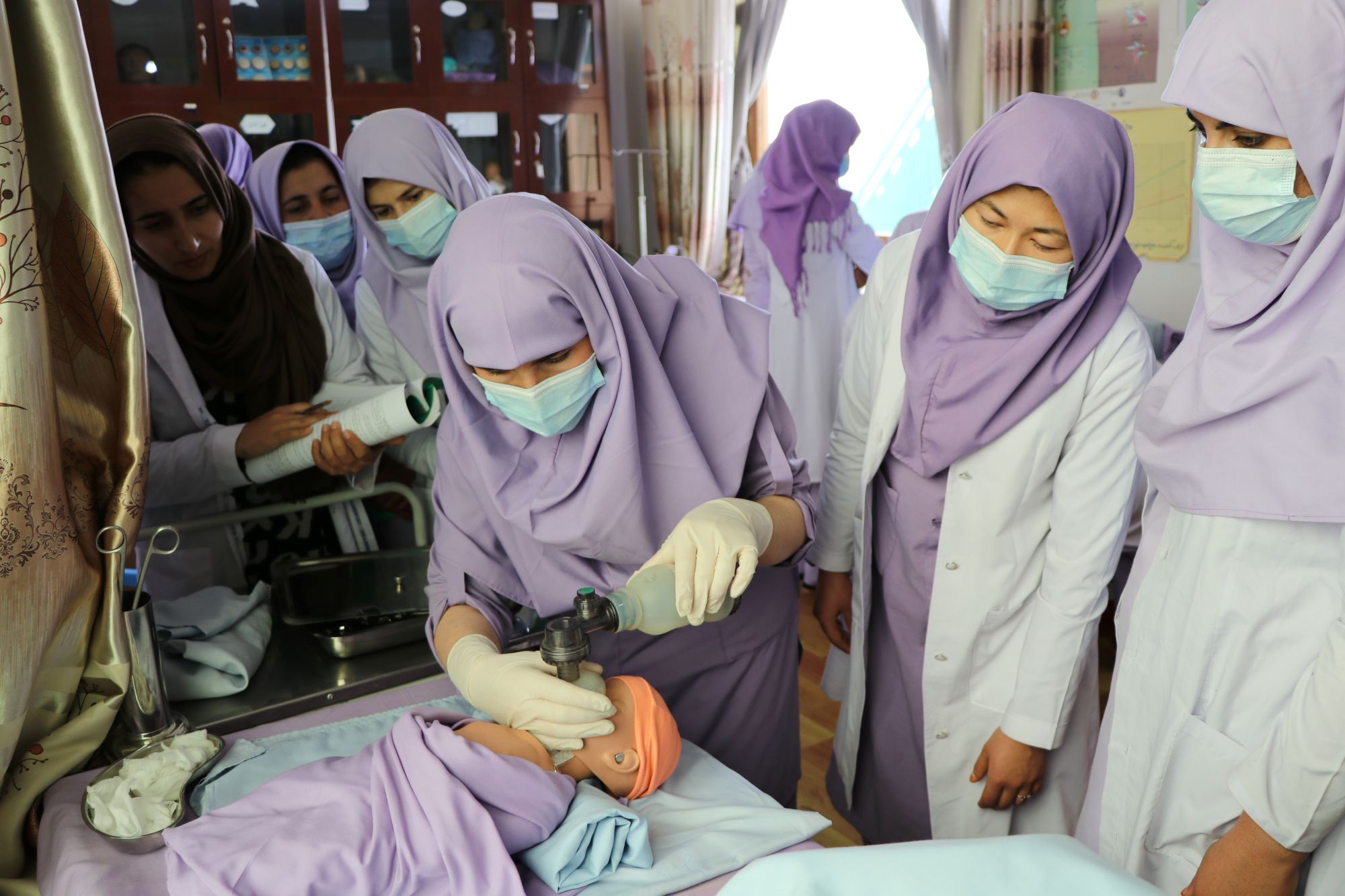 Midwifery students practising on a doll